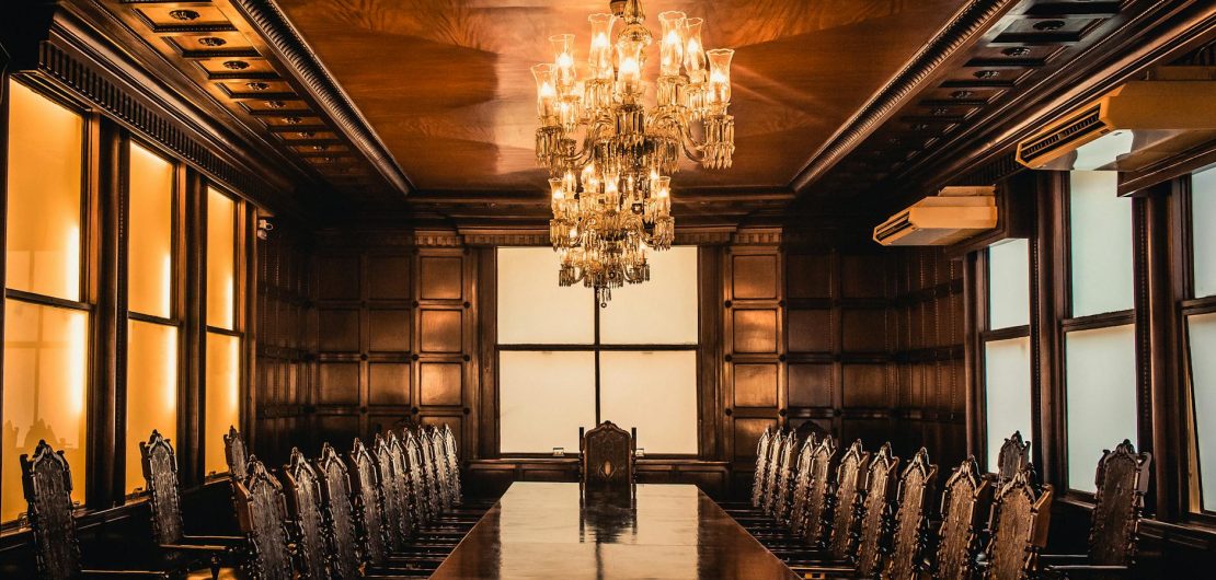 brown wooden table and chairs inside building