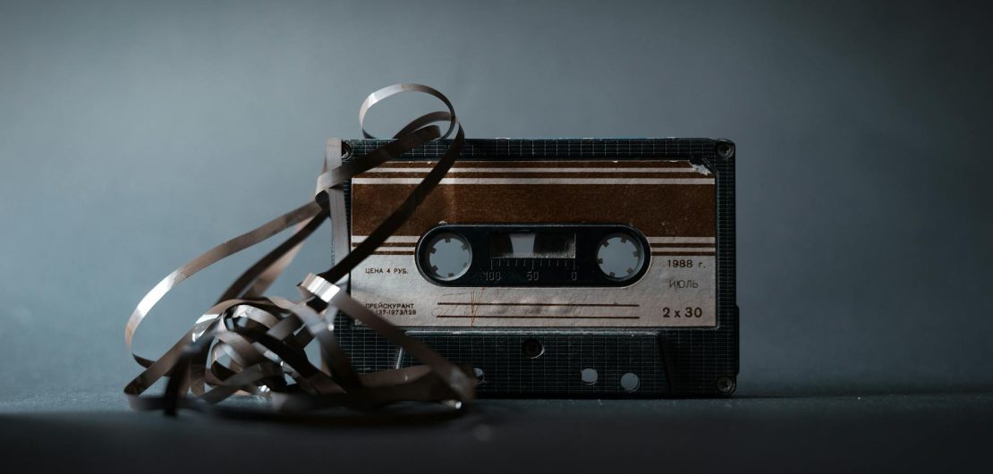 retro cassette with tape on gray background