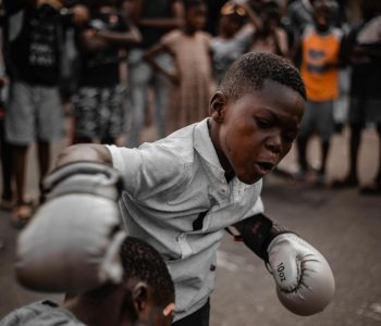 a boy fighting with another boy