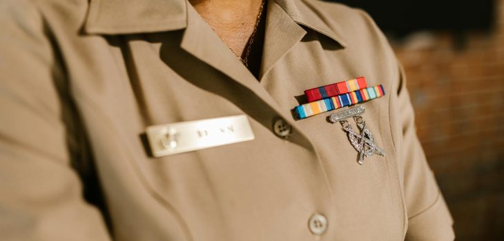 close up photo of person wearing beige military uniform