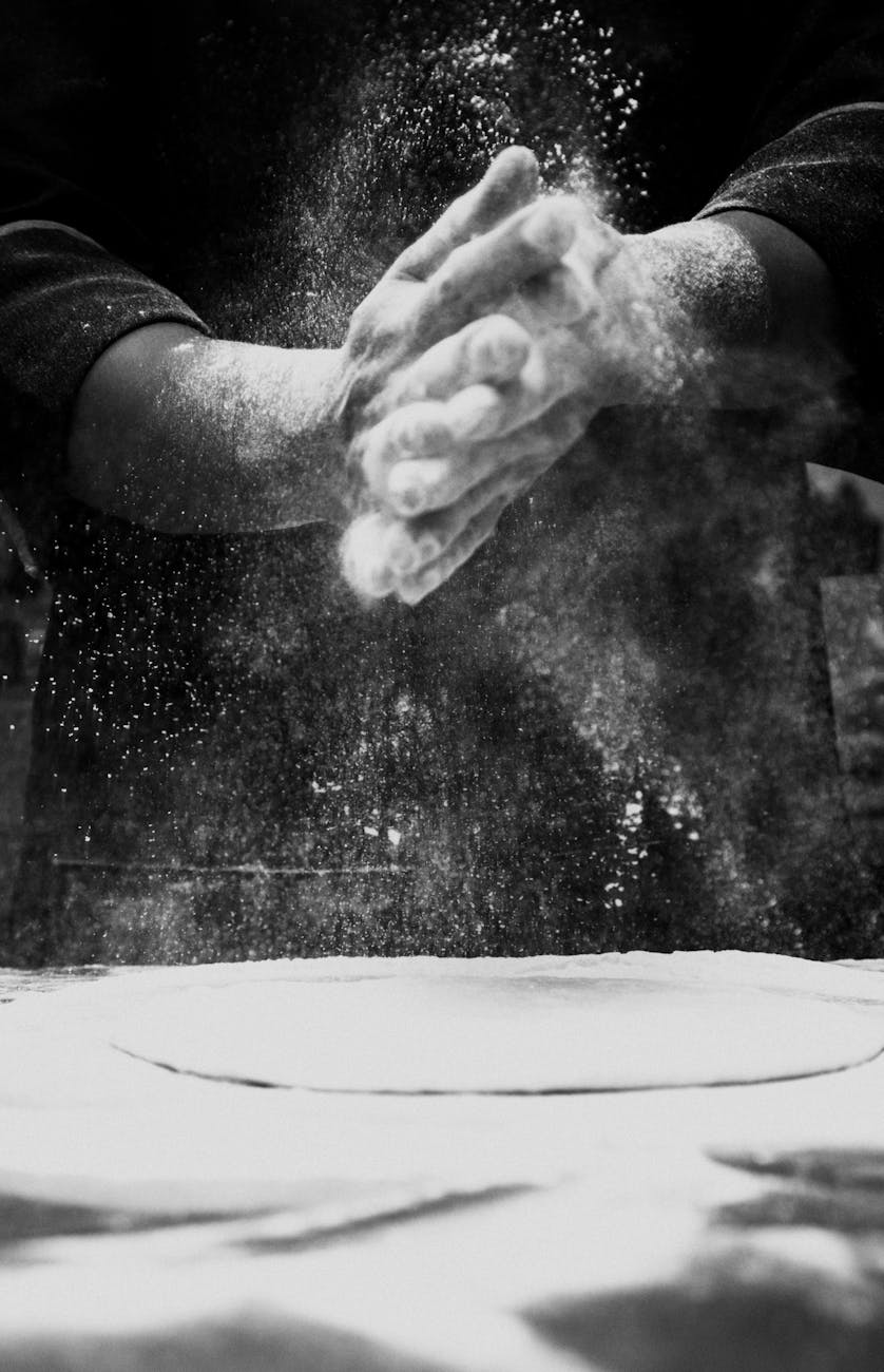 person spreading flour for food