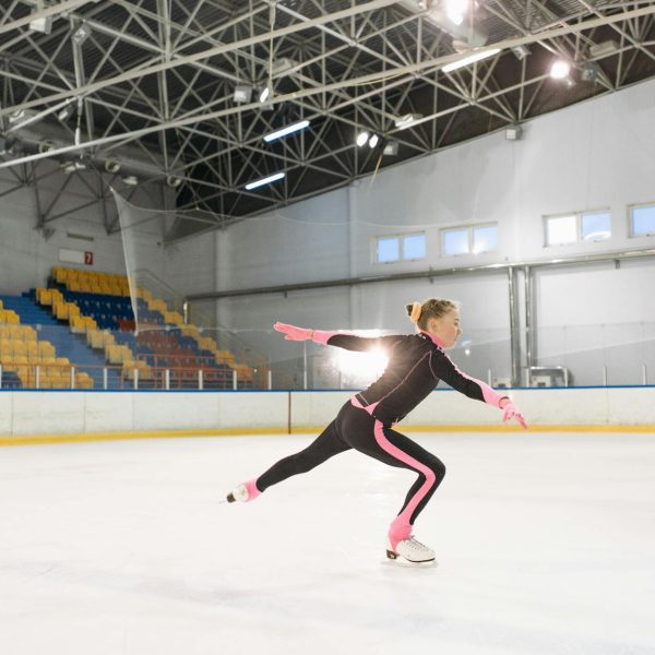 girl in pink and black long sleeve bodysuit doing ice skating