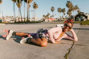 woman wearing rollers skates lying on the floor