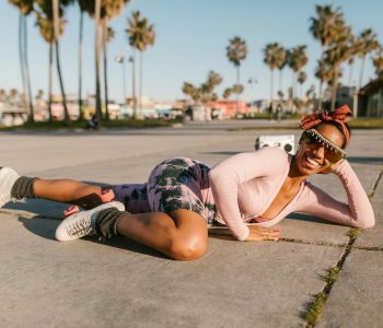woman wearing rollers skates lying on the floor
