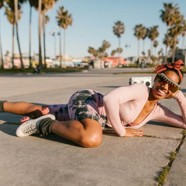 woman wearing rollers skates lying on the floor