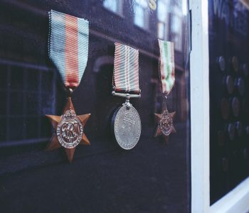 three medals in glass enclosure