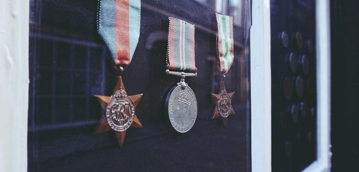 three medals in glass enclosure