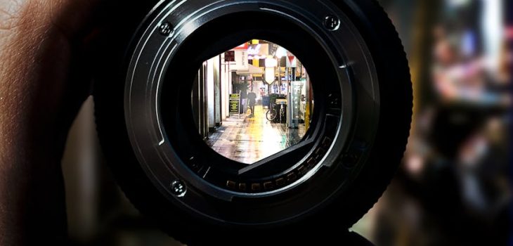 person holding black camera lens