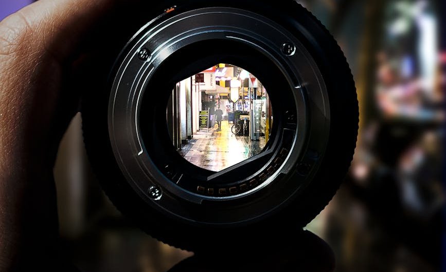 person holding black camera lens