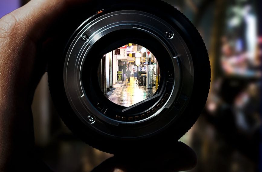 person holding black camera lens