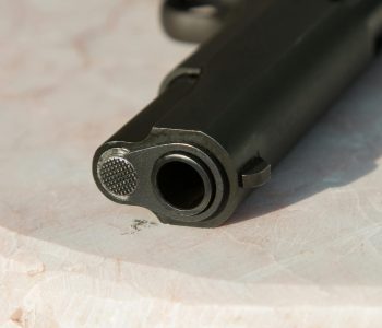 black metal gun on white surface