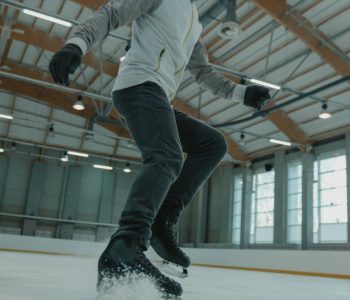 man in white long sleeve shirt and black pants doing skate stunts
