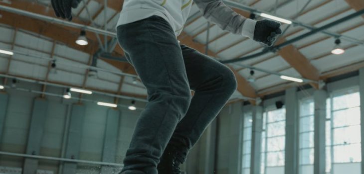 man in white long sleeve shirt and black pants doing stunts