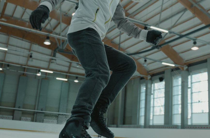 man in white long sleeve shirt and black pants doing stunts
