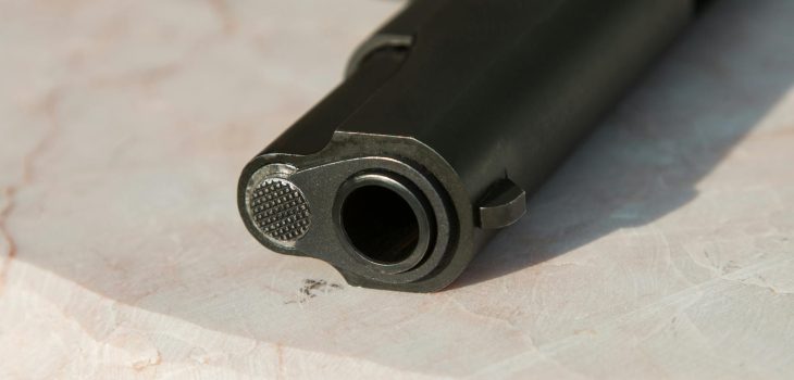 black metal gun on white surface