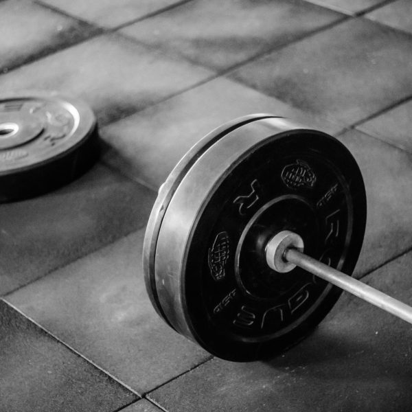 grayscale photo of black adjustable dumbbell