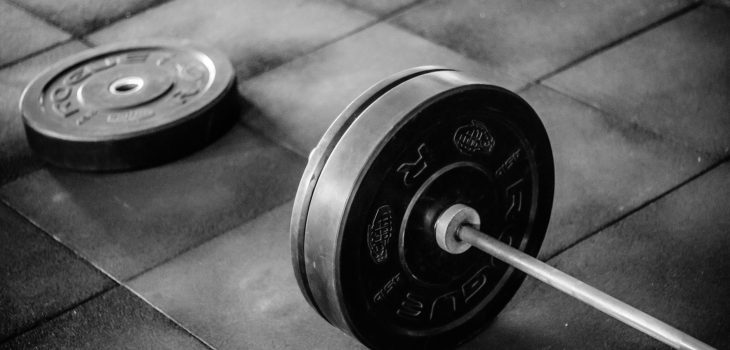 grayscale photo of black adjustable dumbbell
